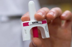 Hand holding Narcan nasal spray