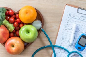 Bowl of fruit next to diabetes test kit